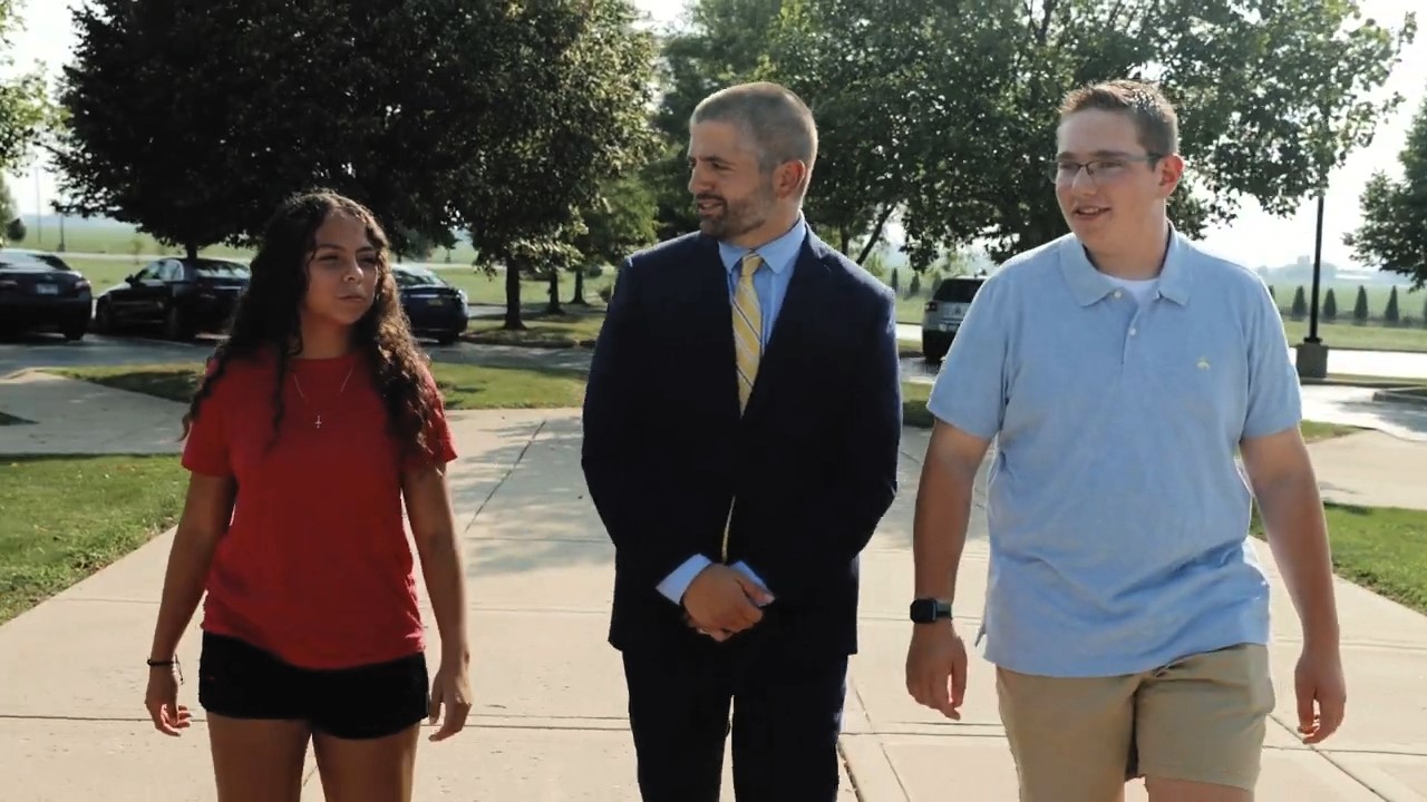 Justin Reyes with two teens